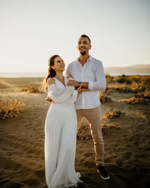 A couple standing together outdoors at sunset